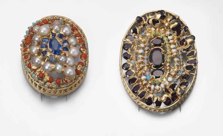 Brooches by Ruth Tomlinson. Yellow gold and silver brooch set with garnet, paste and antique glass measuring, price from £1950. Yellow gold and silver brooch set with pearls, West African glass, price from £1390