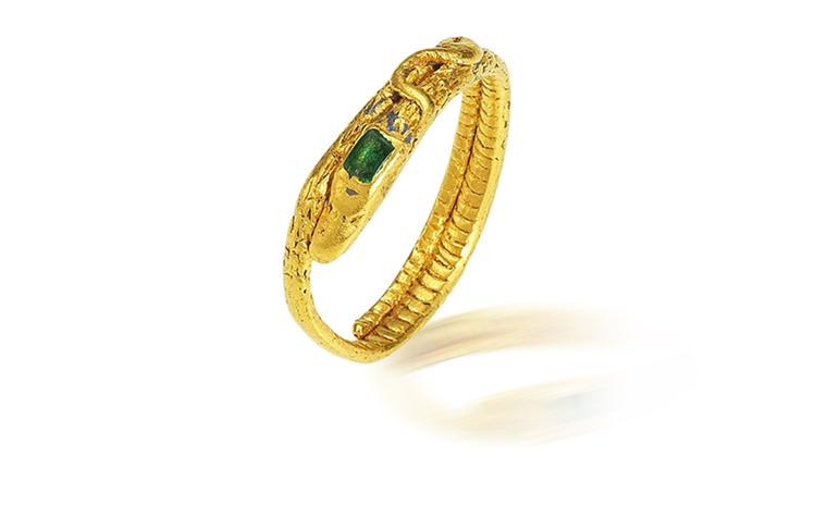 Lot 22. A gold and emerald snake ring, probably 14th-15th century. Estimate £4,000-6,000. SOLD FOR £4,375.