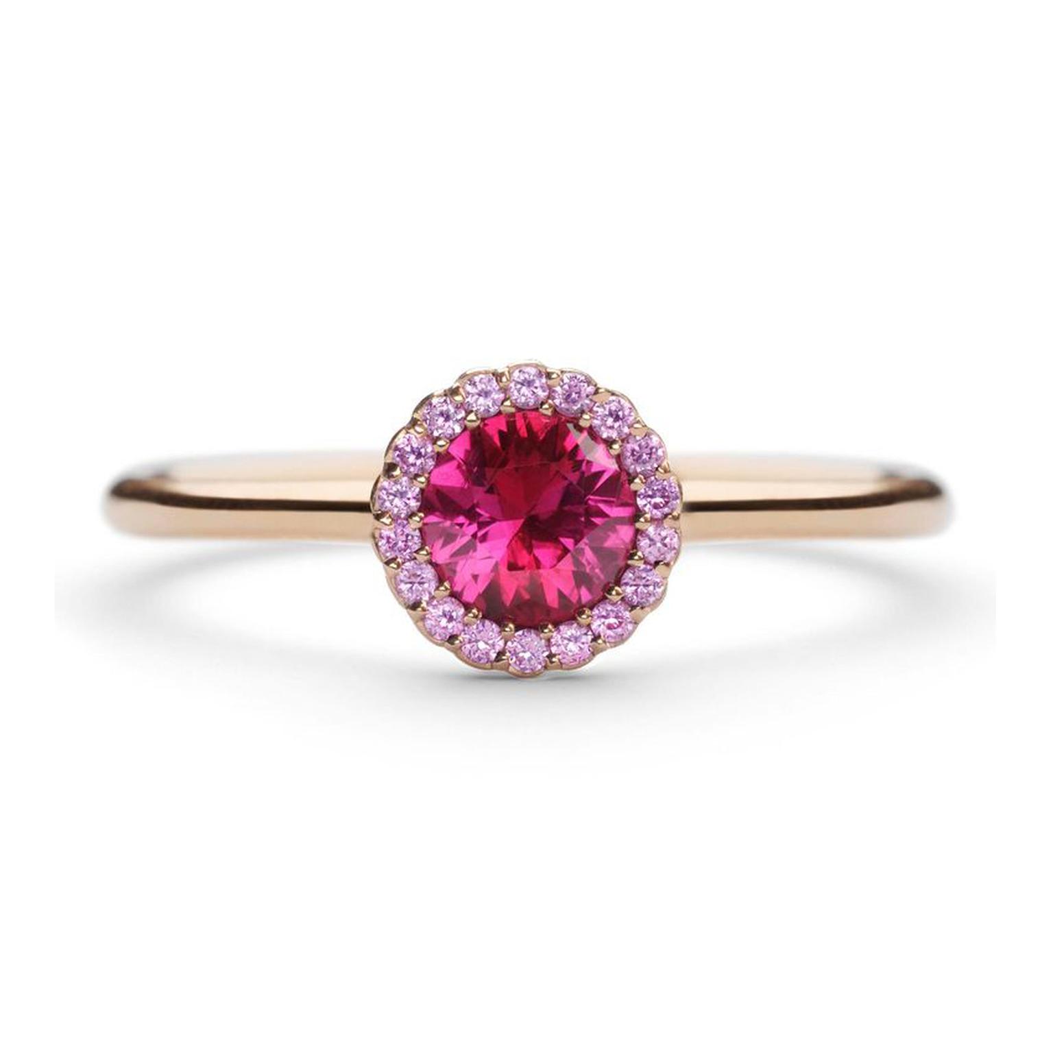 Andrew Geoghegan Cannelé engagement ring in rose gold with a brilliant-cut ruby encircled by pink sapphires.