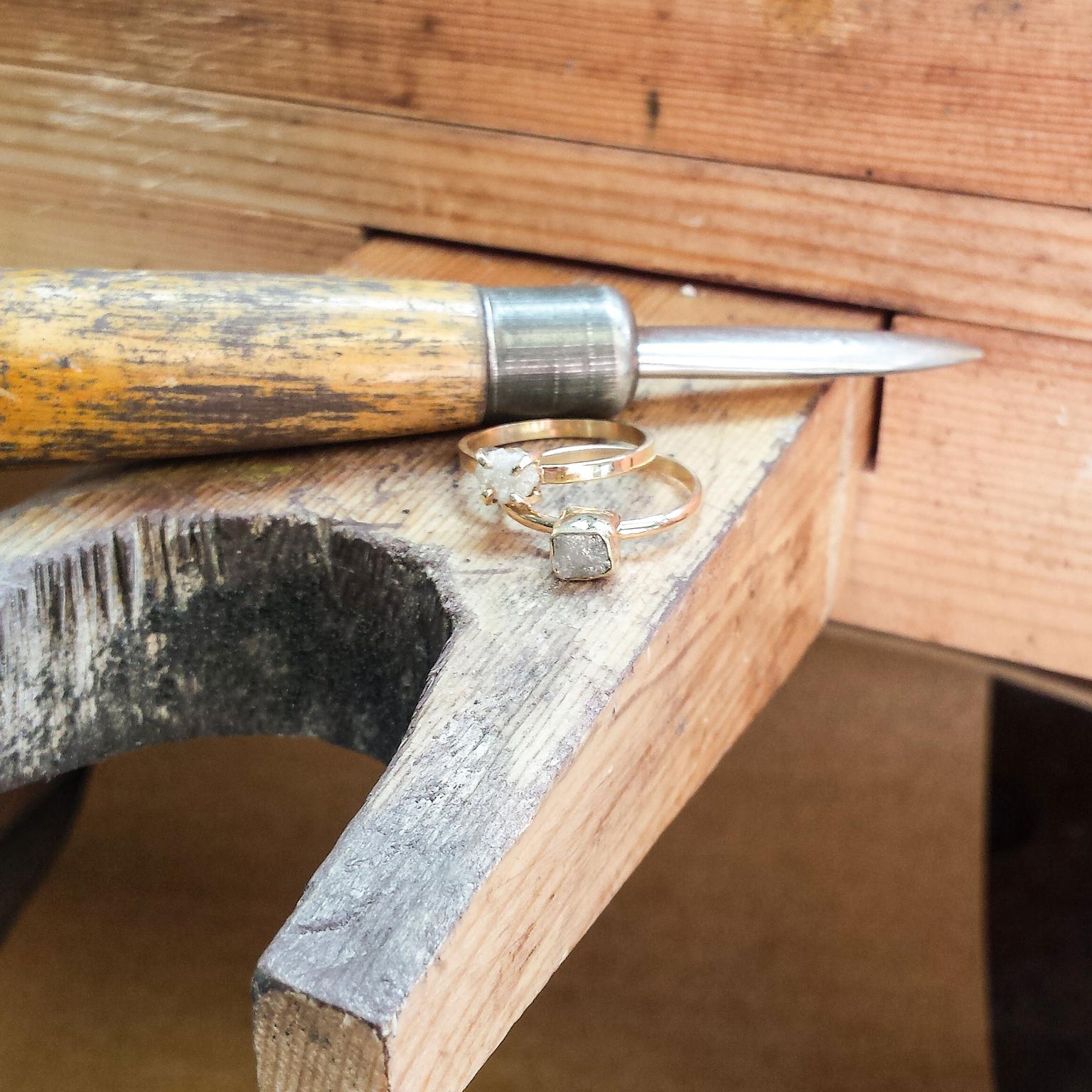 Rough diamond engagement rings on the bench at Point No Point Studio