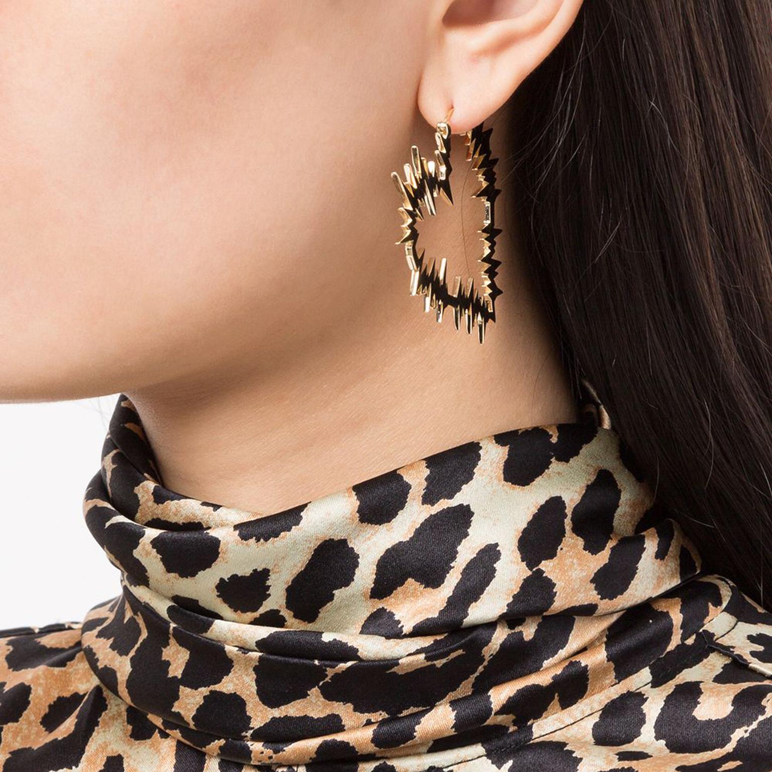 Electric Heart hoop earrings by Karen Walker on model