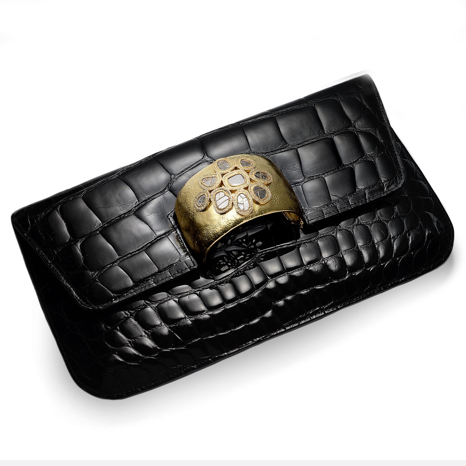 Coomi black leather bag with gold cuff