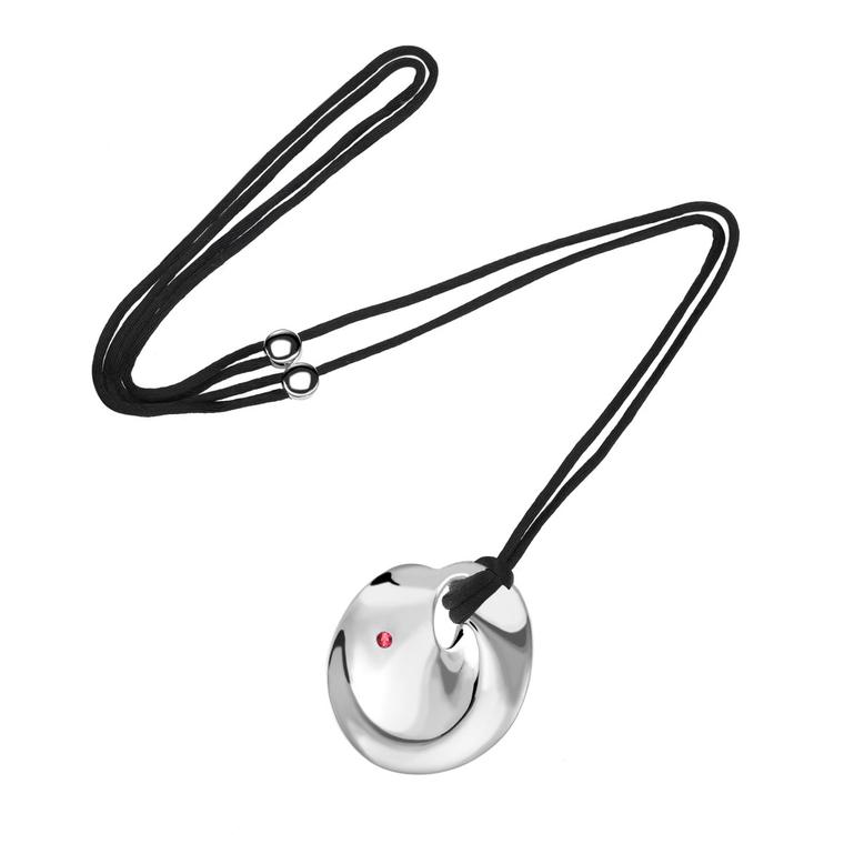 Silver and ruby Mobius pendant on a silk cord