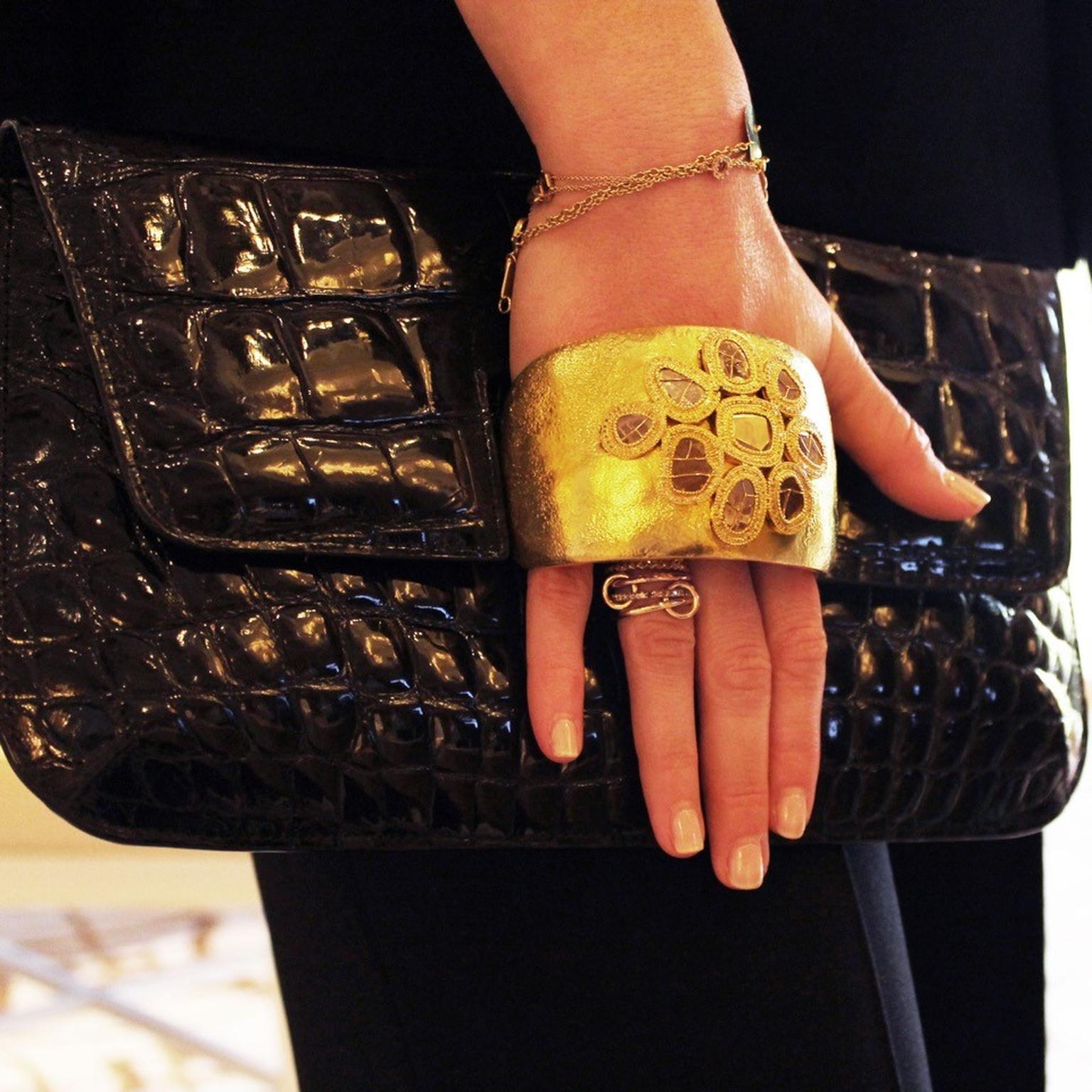 Coomi black crocodile leather bag with gold cuff