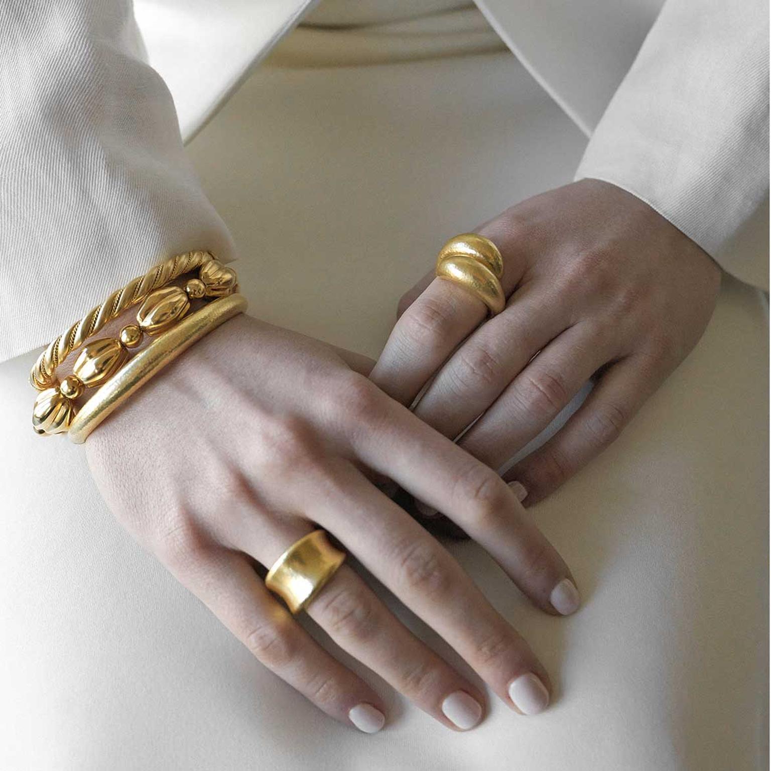 Lalaounis gold rings and bracelets on model