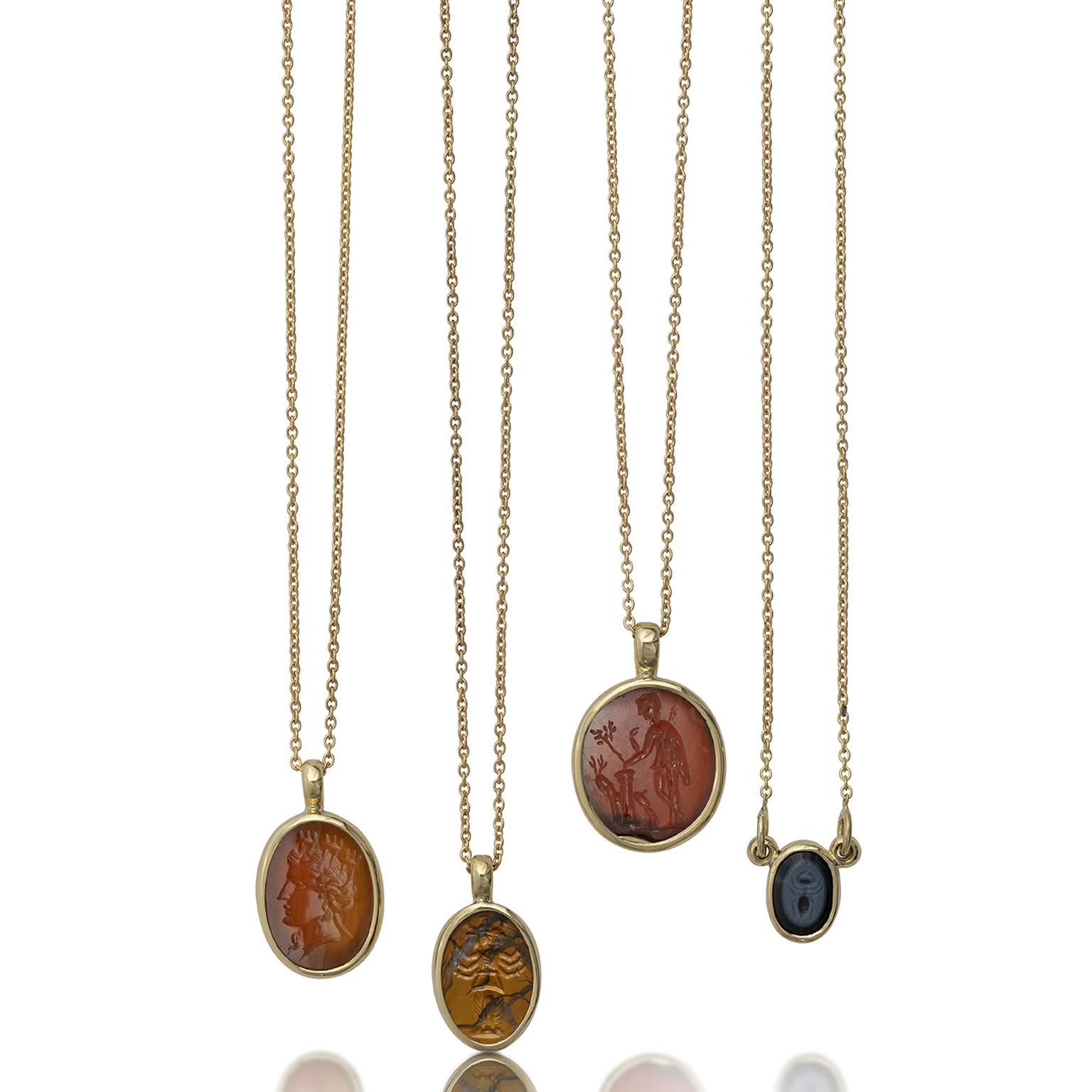 A selection of ancient Roman hardstone intaglios set in modern gold pendants from Kallos Gallery