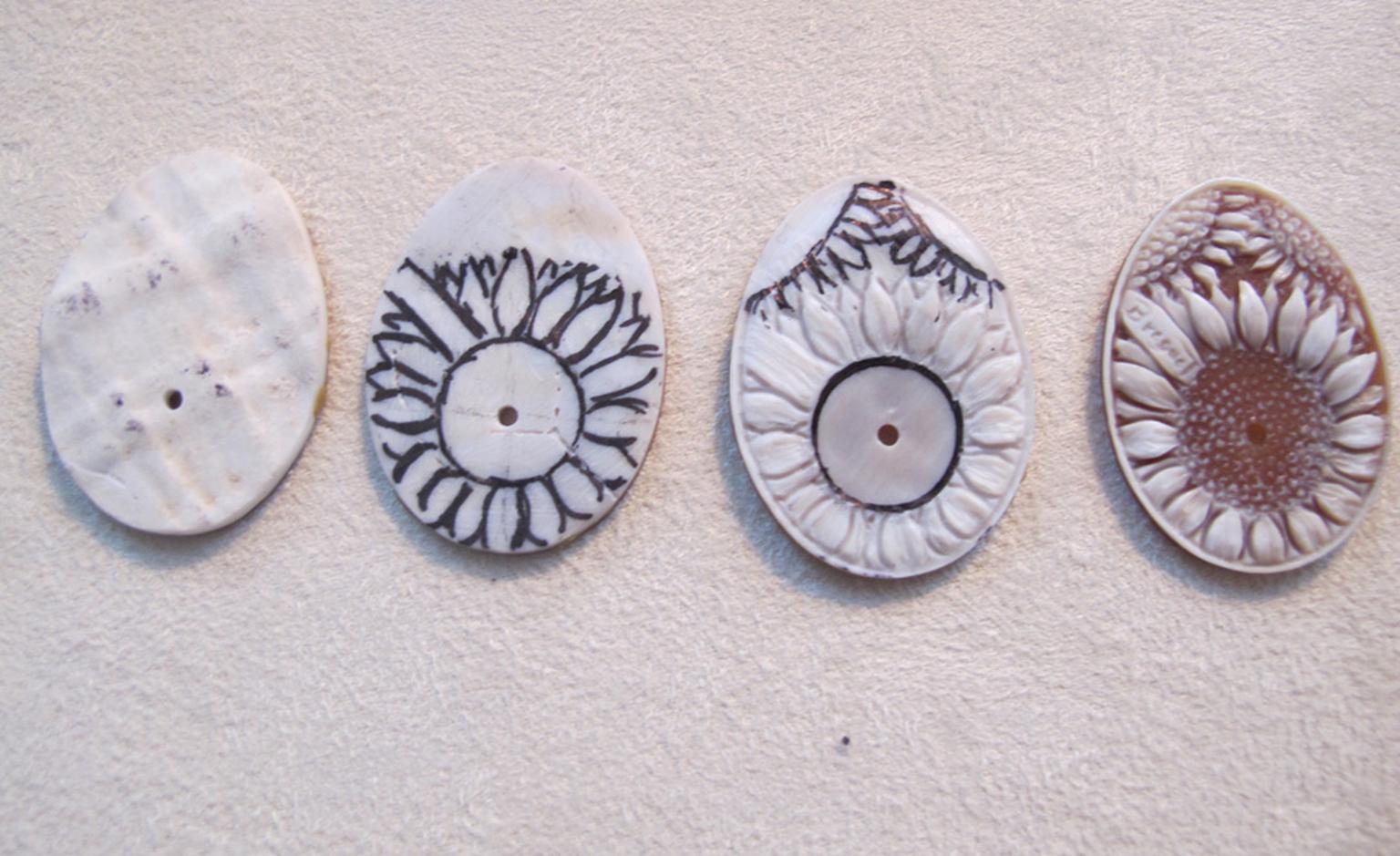The stages of carving a dial from a shell cameo.
