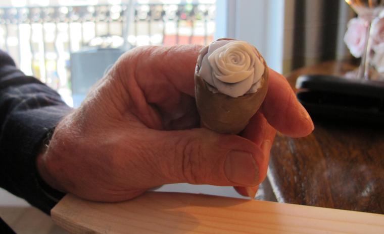 Pasquale Ottaviano holds up a cameo he is carving for Breguet's "La Rose de la Reine" collection.