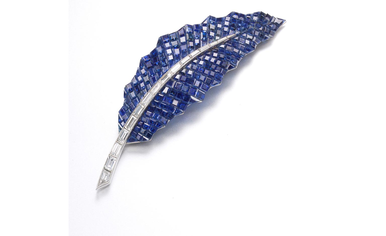 A Mystery-set sapphire and baguette-cut diamond ‘Feuille de Houx’  brooch, by Van Cleef & Arpels, 1969. Estimate: SFr. 45,000-62,000 (US$ 50,000-70,000)