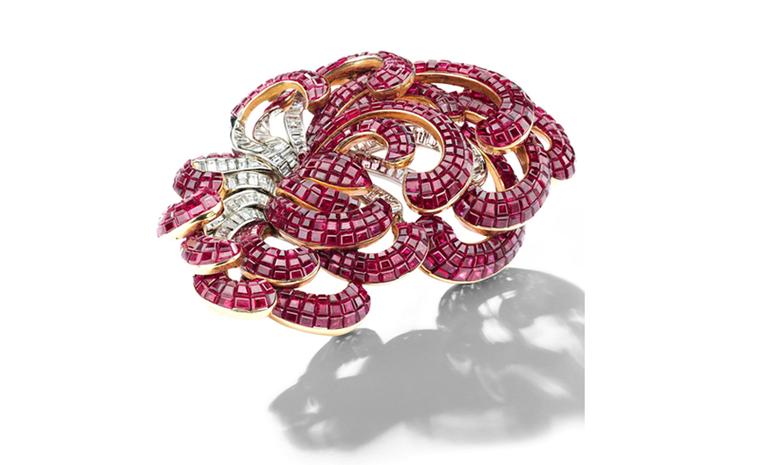 A Mystery-set ruby and baguette-cut diamond scroll brooch, by Van Cleef & Arpels, 1930s. Estimate: SFr. 270,000-450,000 (US$ 300,000-500,000)