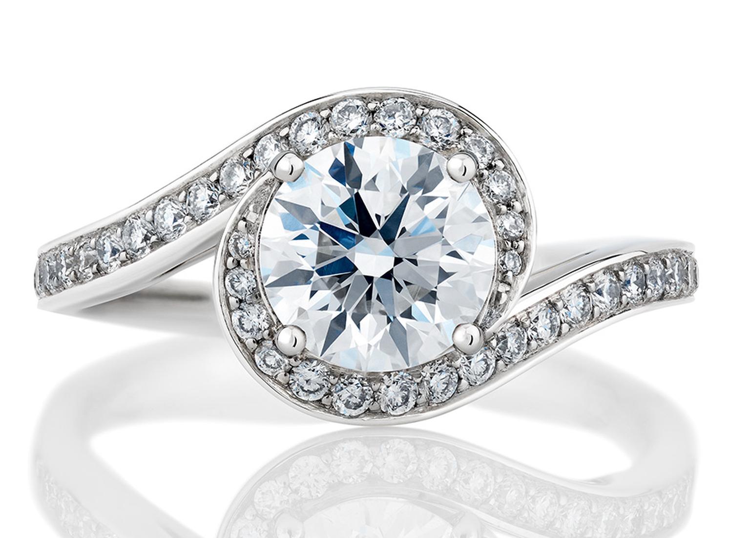 De Beers' Caress solitaire engagement ring incorporates a curved diamond pave´ that appears to embrace the central diamond