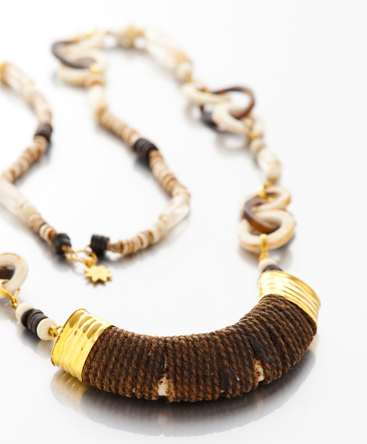 Lisa-Black-Boars-Tusk-Pendant-on-Necklace-of-Shell-and-Tortoise.jpg