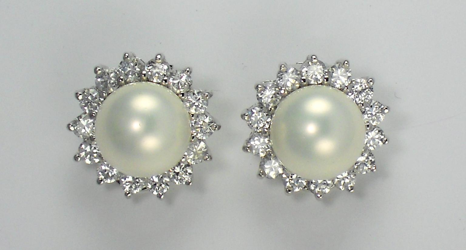 CIRO. Sterling silver rhodium plated shell pearl earrings with brilliant cut cubic zirconia stones.jpg