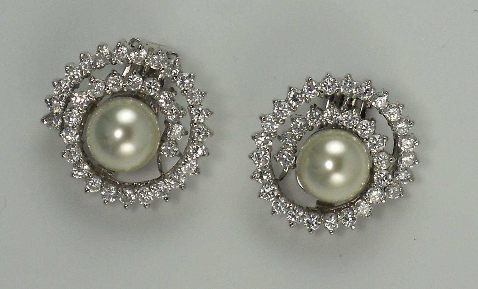 CIRO. White Shell Pearl set in sterling silver rhodium plate swirl with white cubic zirconia brilliant cut stones.jpg