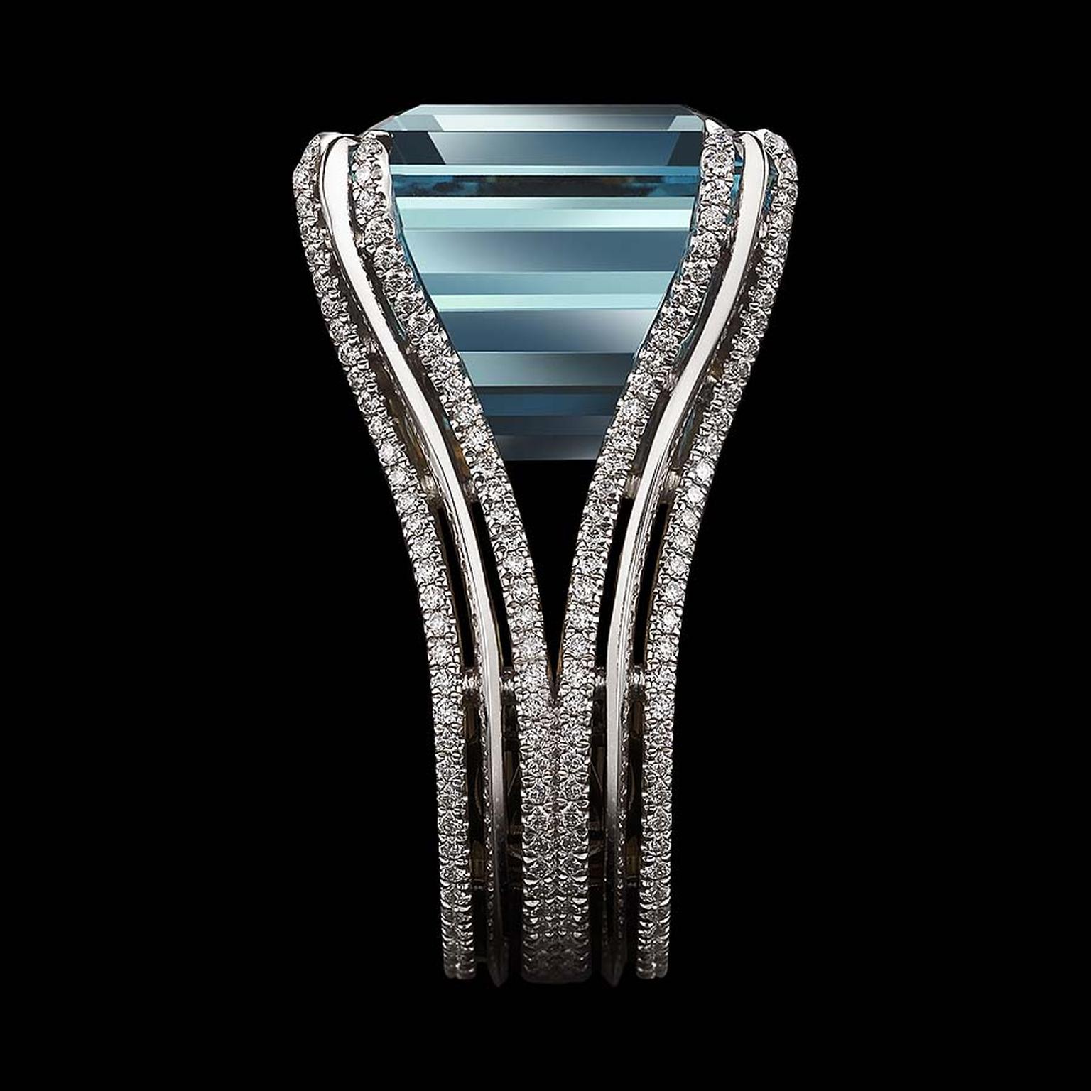 Double bands of platinum and gold hold the aquamarine in place, and it is set with "floating" melee diamonds.