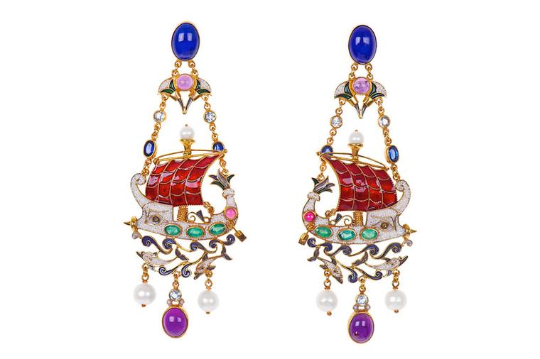 Percossi Papi earrings depicting a Phoenician ship, with a protective Isis eye and dolphins made with lapis lazuli, sapphires, emerald, ruby, amethyst and blue topaz. The hull of the ship is made from natural pearl micromosaic.