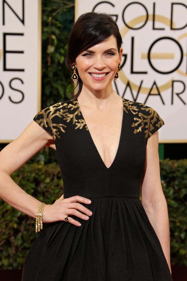 Julianne Marguilies wore 1973 estate earrings in onyx, coral and diamonds, a vintage Ludo bracelet circa 1951 and an Alhambra onyx and diamond ring, all by Van Cleef & Arpels, to the 2014 Golden Globes