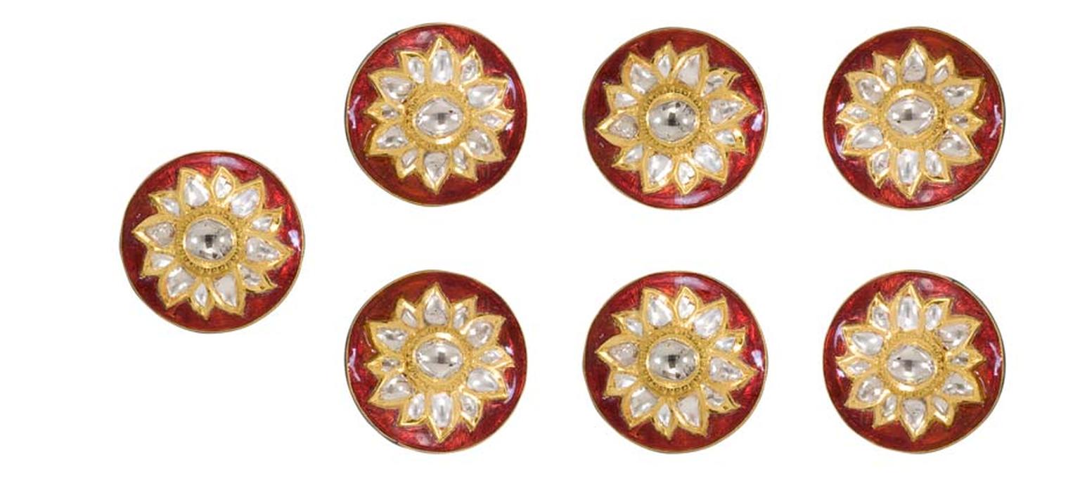 A set of seven Sunita Shekhawat sherwani buttons featuring kundan polki and red enamel.