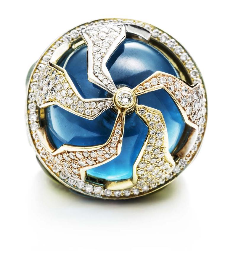 Kara Ross' Pangea ring has five moveable pieces that move independently above the blue topaz cabochon