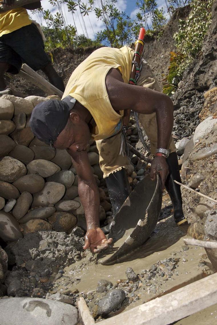 Panning for Fairtrade gold in banked trenches to reduce soil erosion