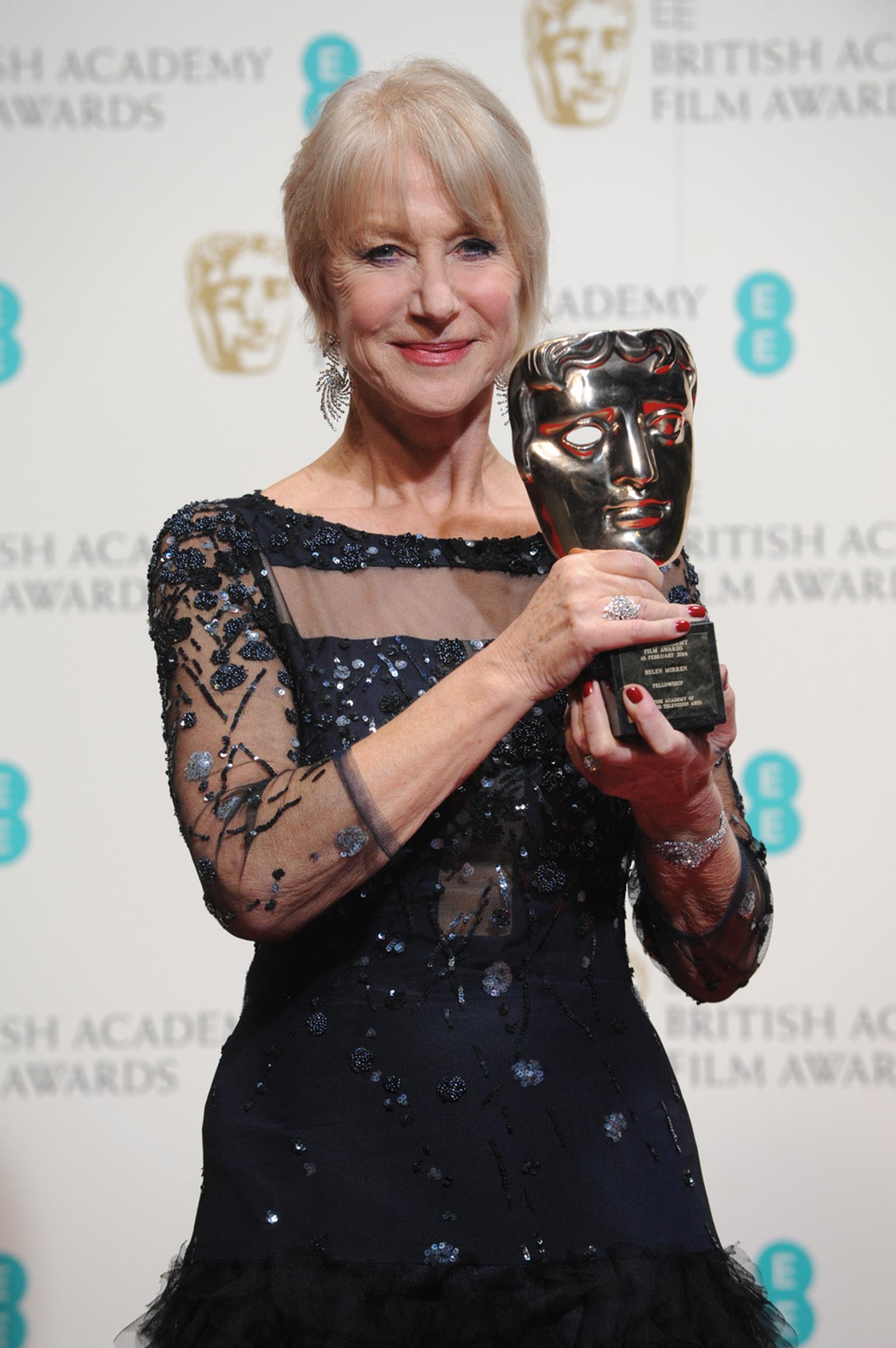 Helen Mirren collects her BAFTA Academy Fellowship Award wearing the earrings, ring and cuff from Asprey's new Storm suite of jewels