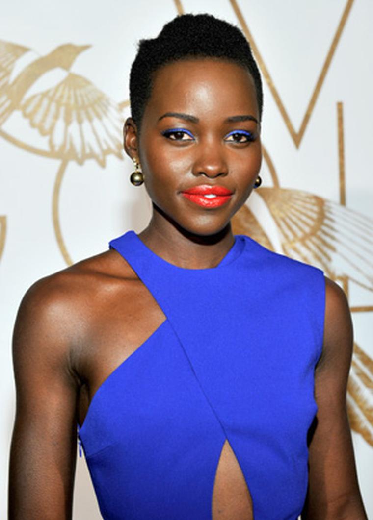 Lupita Nyong'o wore Elena Votsi gold and diamond earrings and a gold ring to a LoveGold event held in LA in her honour on 26 February 2014