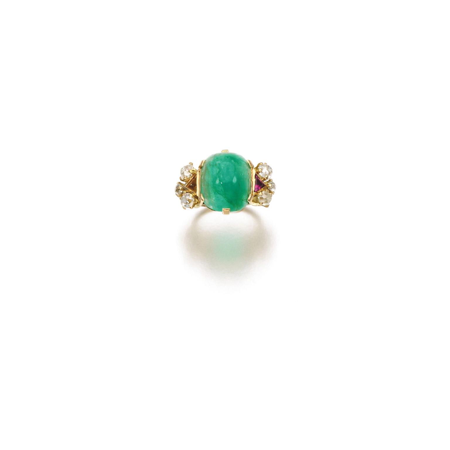 Lot 102, from the Daisy Fellowes collection, an emerald, ruby and diamond ring featuring a sugarloaf cabochon emerald set between triangular ruby shoulders, further decorated with circular-cut diamonds - one ruby deficient (estimate: £3,000-5,000; unsold)
