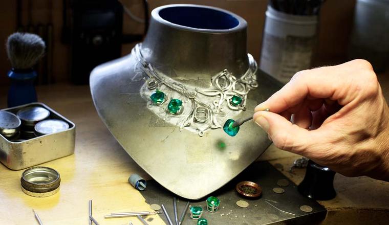 Seven cushion-cut emeralds totalling 46.2 carats being set into Boodles' Greenfire emerald necklace