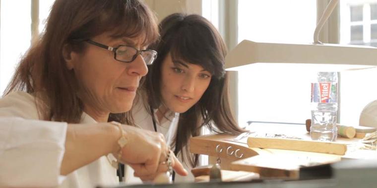 A student observes a jewellery professor in the L'École Van Cleef & Arpels Gemmology atelier