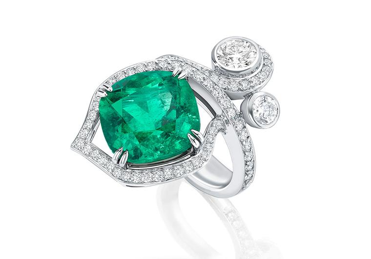 Boodles' Greenfire emerald ring, part of the Greenfire suite, features a single emerald surrounded by pavé diamonds and two brilliant-cut diamonds designed to appear as entwined forest foliage