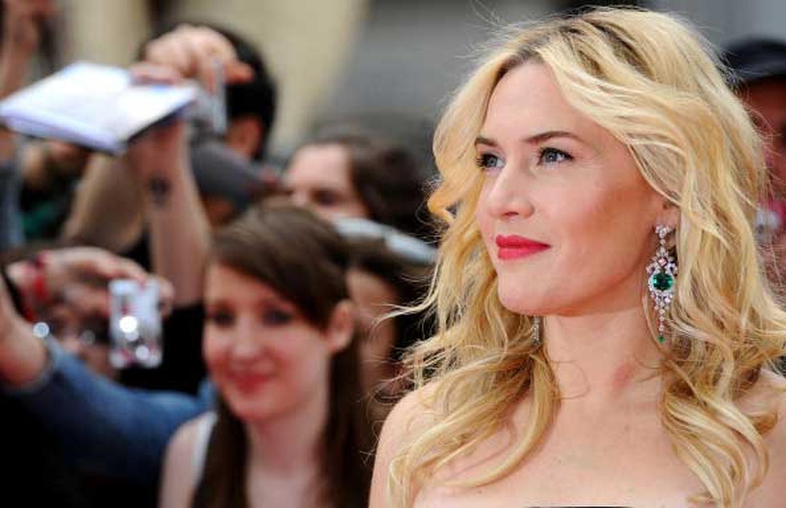 Kate Winslet looks radiant in David Morris emerald and diamond earrings as she says hello to fans at the London premiere of her new film, Divergent
