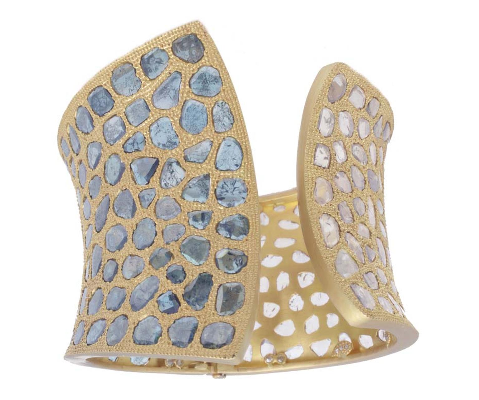 Coomi gold cuff with blue diamonds.