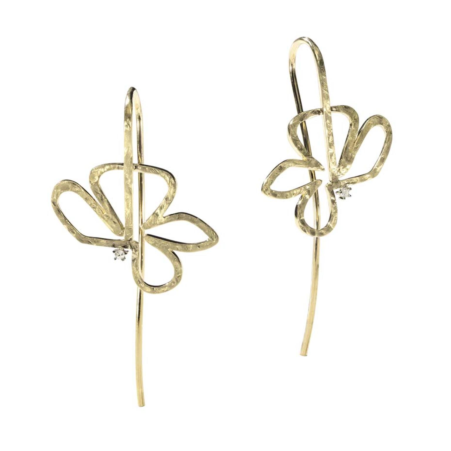 H.Stern's 2014 Oscar Niemeyer collection gold earrings featuring one diamond each displays a hollow flower design, representing Niemeyer’s love of empty spaces.