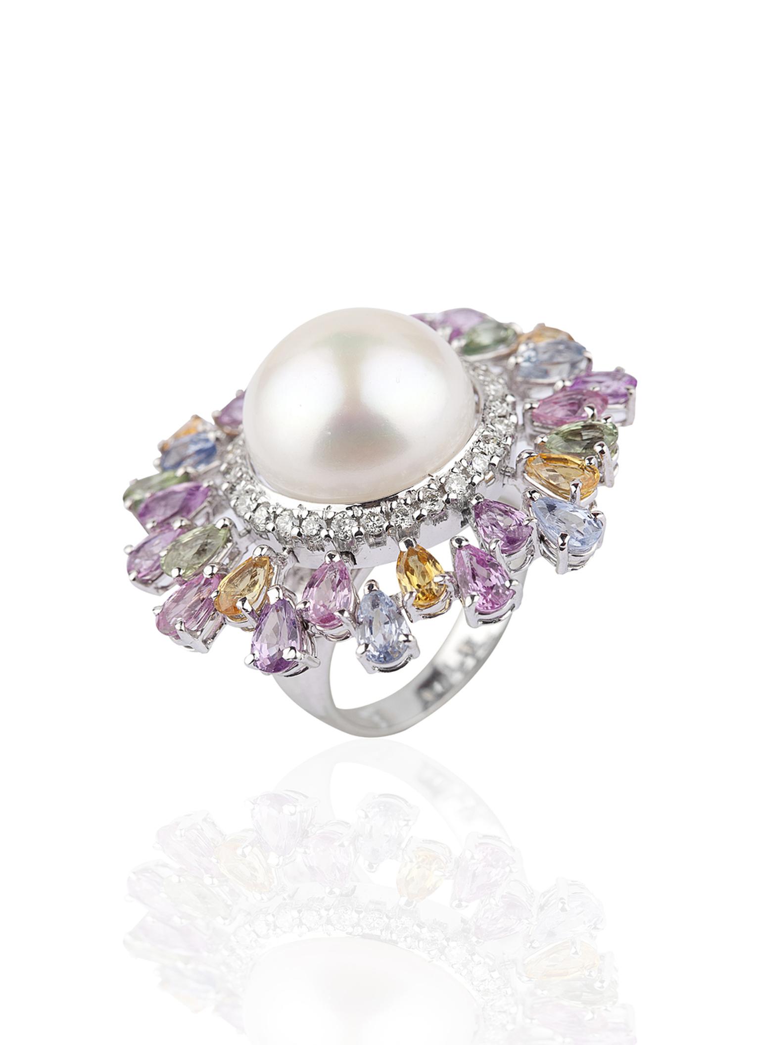 Mirari white gold ring featuring multi-coloured sapphires and round brilliant cut diamonds surrounding a freshwater button pearl.