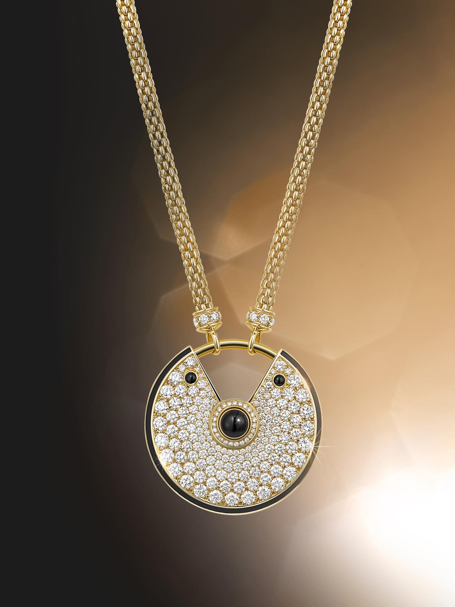 Amulette de Cartier large gold and black lacquer pendant with diamonds and three onyx cabochons.