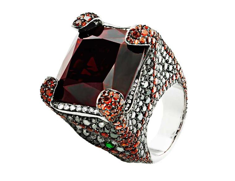 Crow's Nest Deluxe Russian Grooves white gold ring in black rhodium with white diamonds and black diamonds, accompanied by a red garnet - one of many impressive pieces that this Russian jeweller will be showcasing at the Couture Show Las Vegas