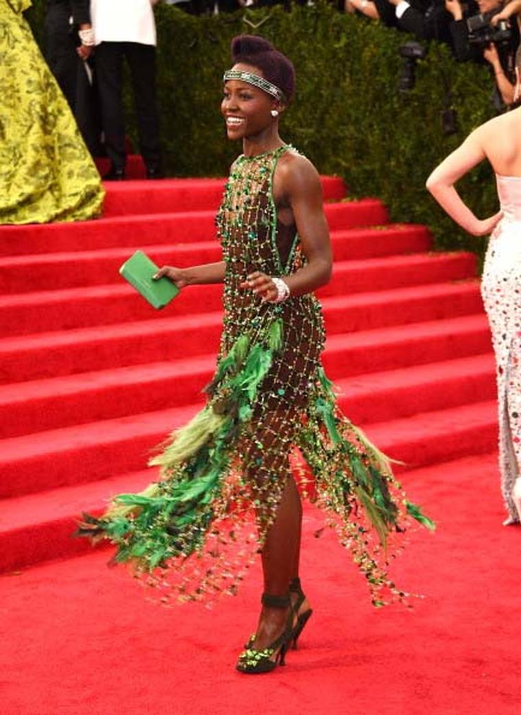 Lupita Nyong'o wore the most flamboyant outfit of the night courtesy of Prada and didn't hold back on her jewels either. She wore a vintage 1906 diamond headpiece, two vintage diamond bracelets, a parrot ring, diamond earrings and an emerald and diamond b