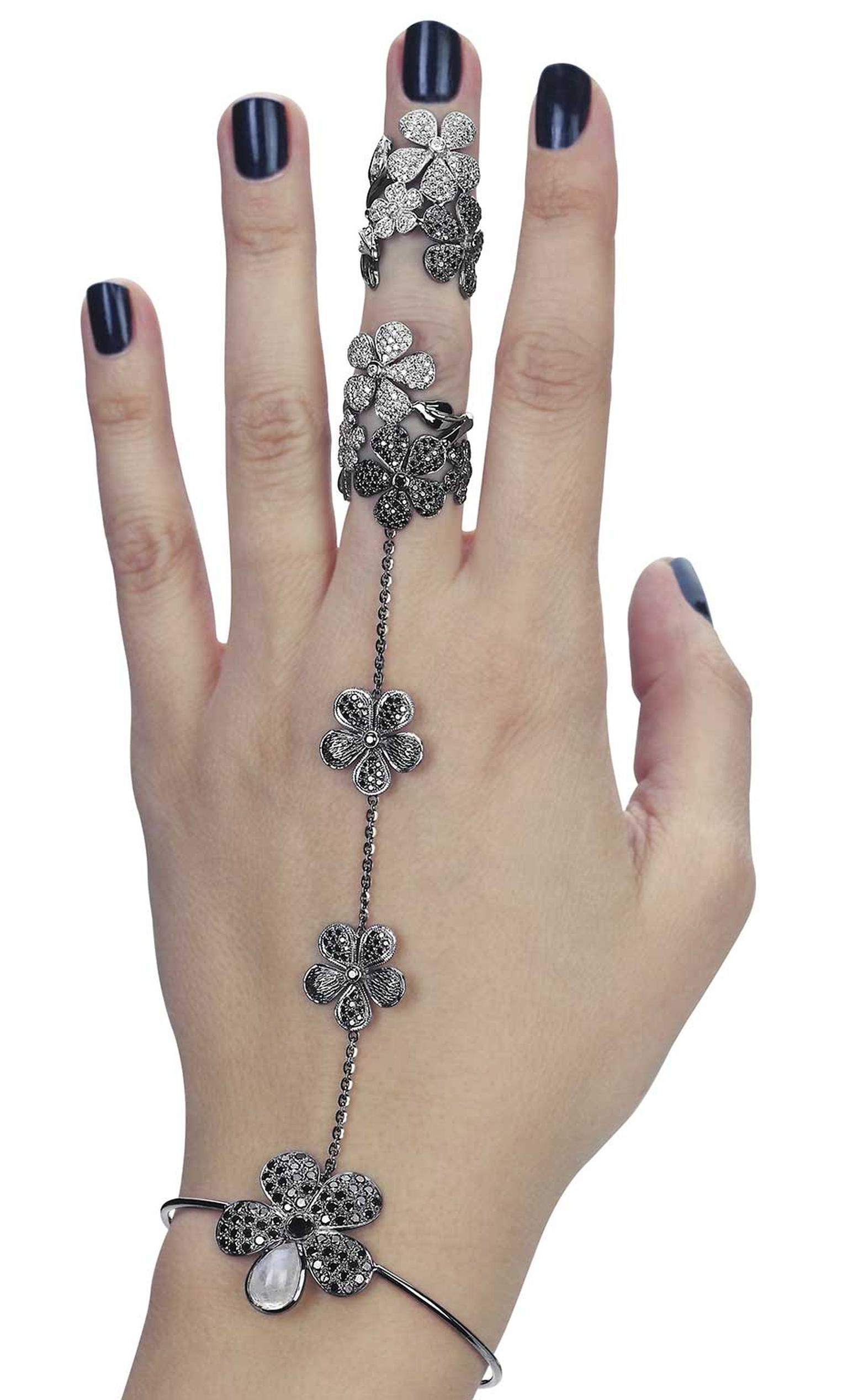 Colette's flower hand jewel wraps around the wrist and middle finger in a fashionable mix of black and white diamonds. See it at the Couture Show Las Vegas