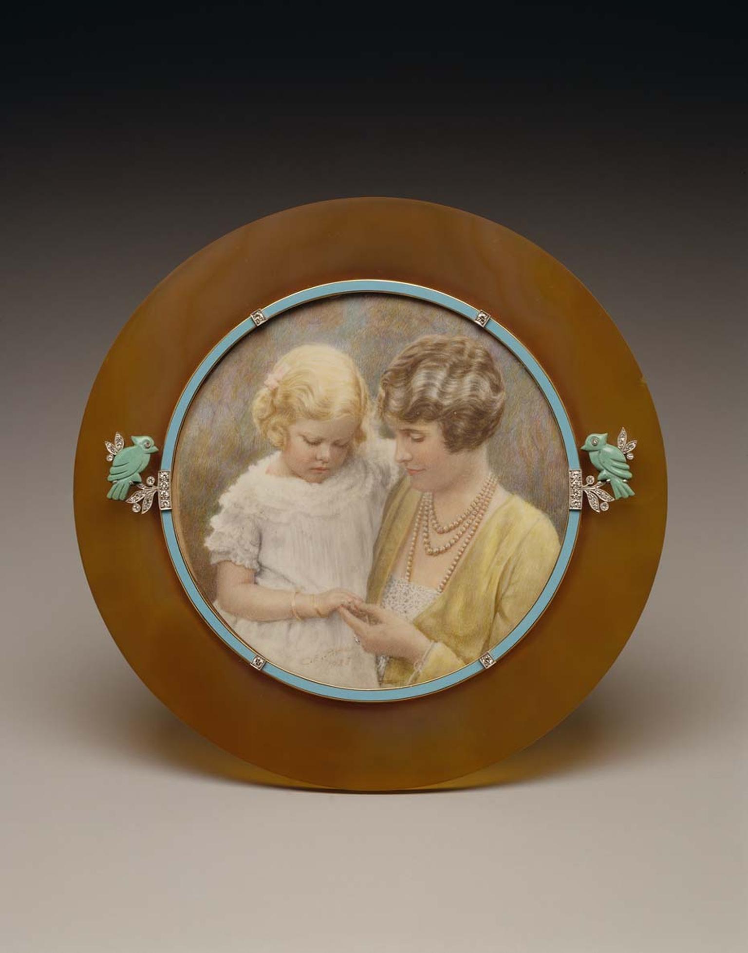 Cartier 1928 gold frame with agate, enamel, diamonds and turquoise displaying a photo of Marjorie Merriweather Post and her daughter, Nedenia Hutton. Image: Courtesy Hillwood Estate, Museum and Gardens.