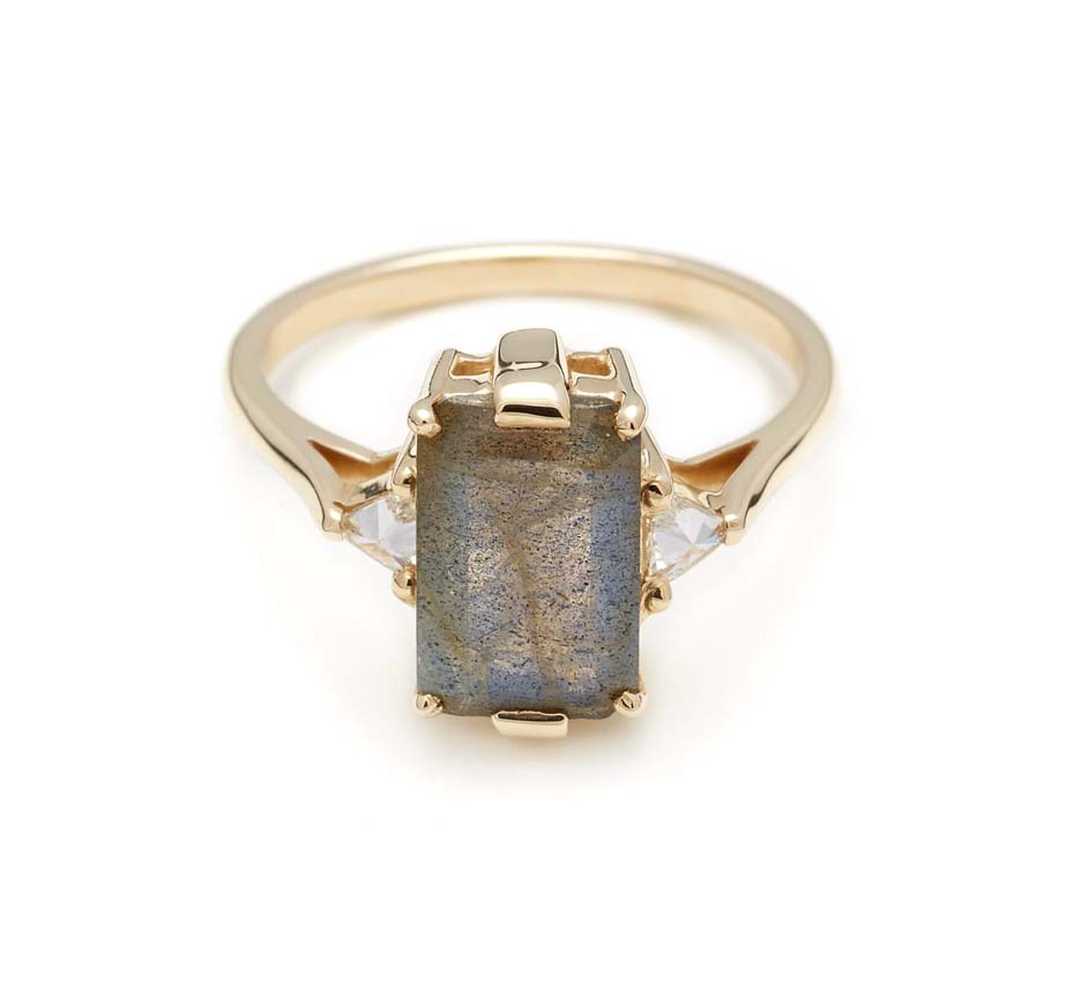 Anna Sheffield Bea three-stone engagement ring with an emerald-cut labradorite set in a signature bridal signature basket, flanked by inverted white diamond trillions in yellow gold