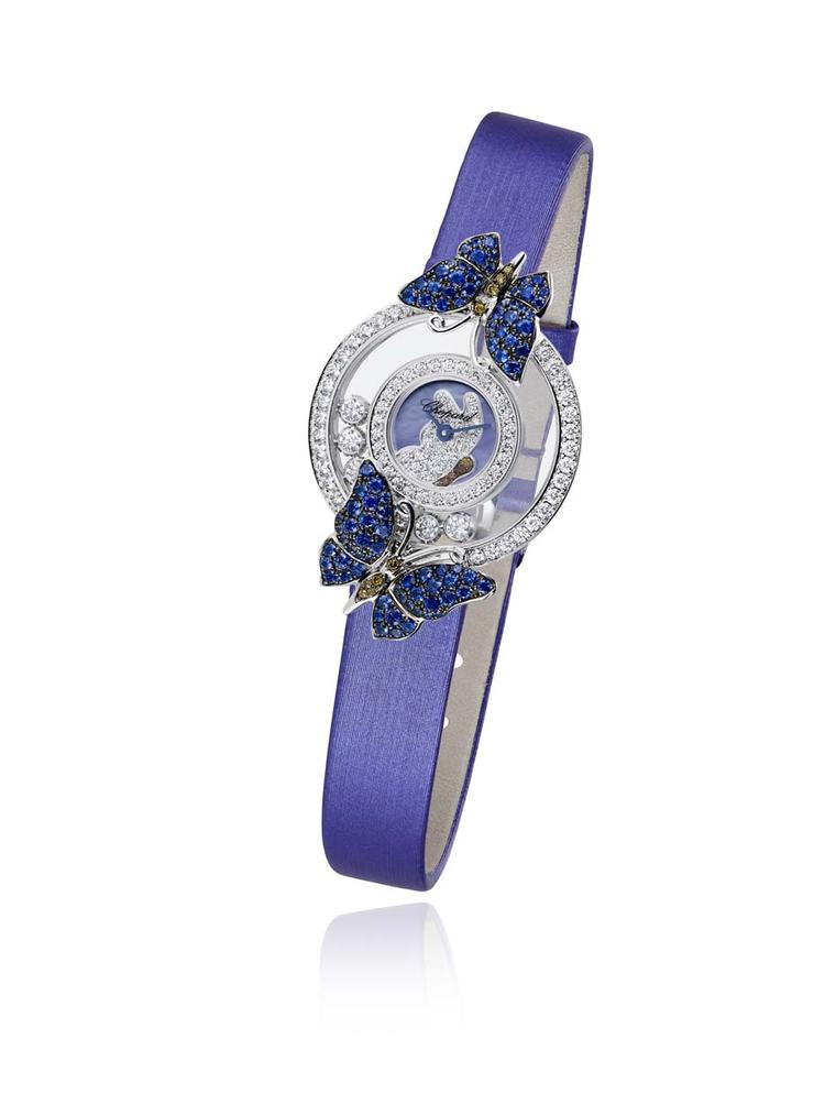 The Chopard Happy Diamonds Butterflies watch features two butterflies decorated with sapphires and brown diamonds, resting on the diamond-set case, with seven mobile diamonds twirling playfully in between