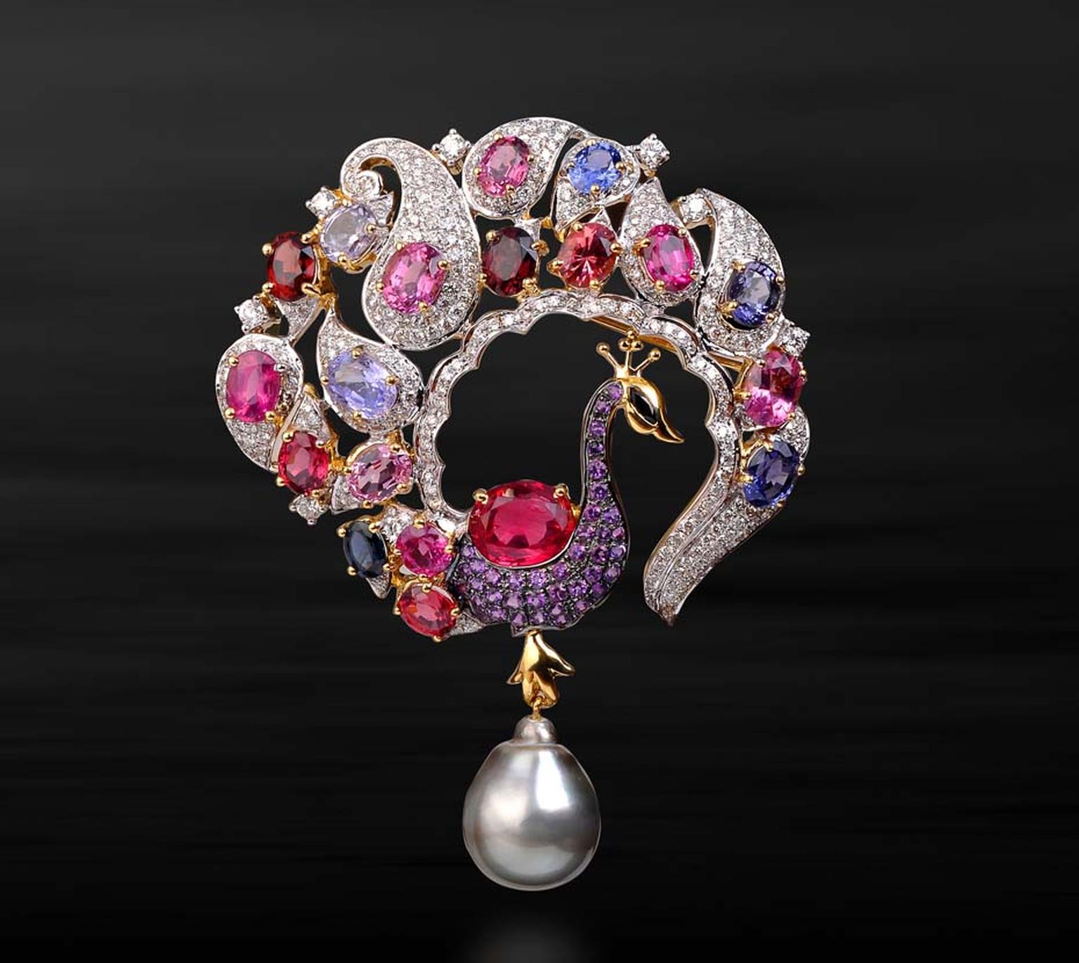 Farah Khan Peacock brooch with a paisley motif tail with a grey pearl, studded with multi-coloured gemstones.