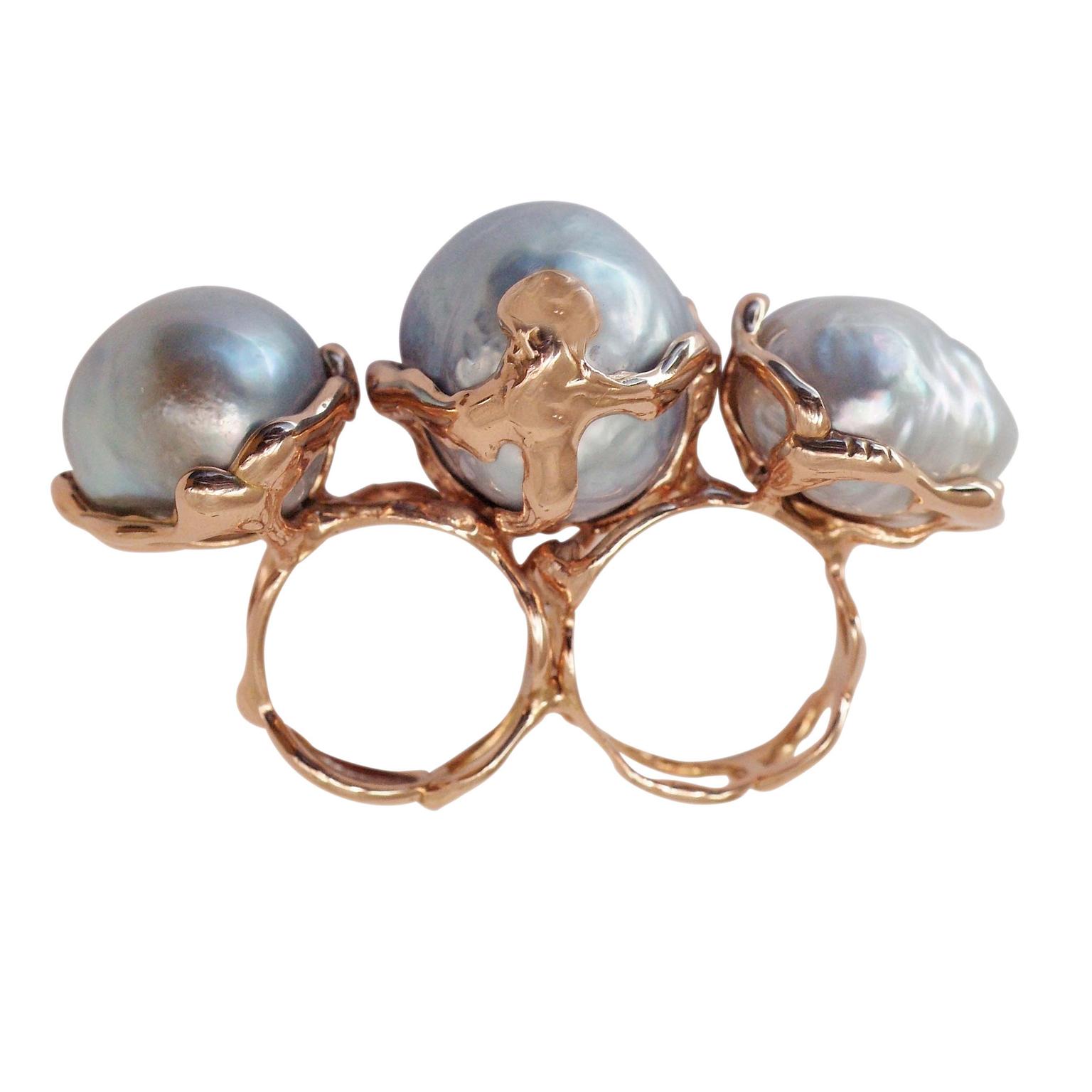 Lucifer Vir Honestus multi-finger pearl ring.