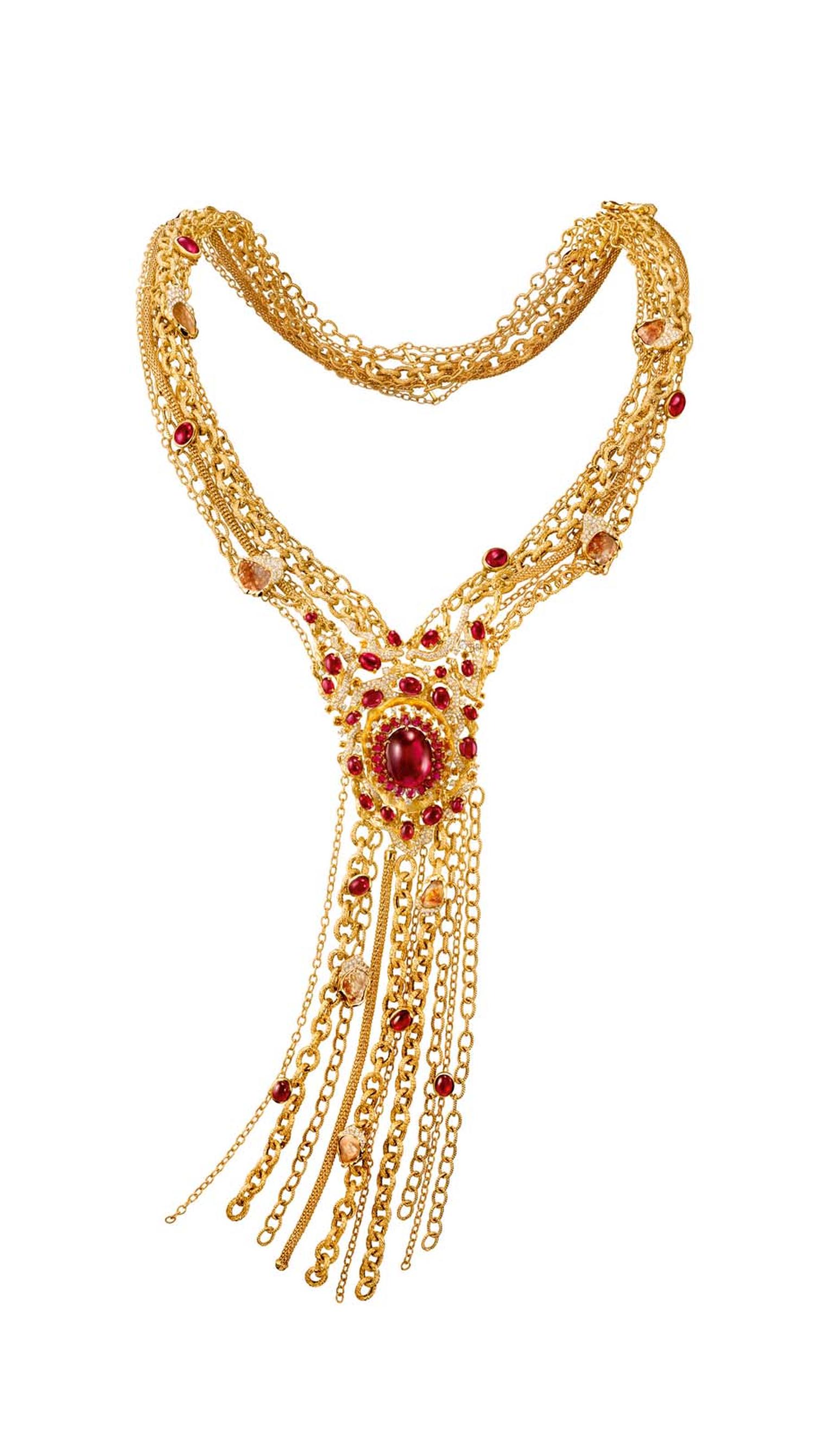 Chow Tai Fook's gold Chant necklace from the Reflections of Siem high jewellery collection, set with a 27.65-carat oval red tourmaline cabochon set in yellow gold, with tassels mimicking the roots of a banyan tree, diamond-studded branches and tourmaline 