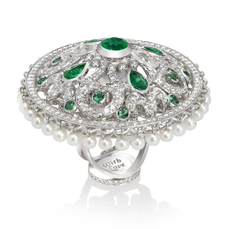 Sybarite Dancing Dolls collection white gold ring with emeralds, diamonds and pearls featuring a bottom plate hidden under the finger stating 'with love'.