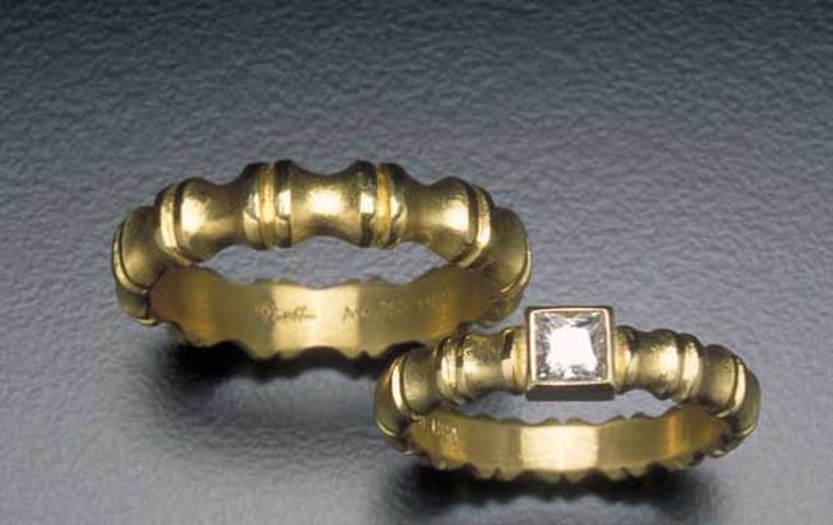 Alexandra Hart men's wedding band with raised gold burnished edges alongside a matching recycled gold bezel-set princess cut G VS diamond engagement ring.