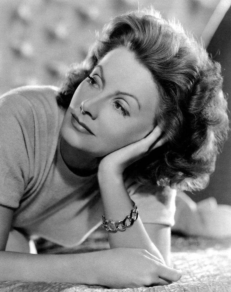 A demure Greta Garbo in a photograph taken by the famous photographer Clarence Sinclair Bull wearing a Verdura gold bracelet.