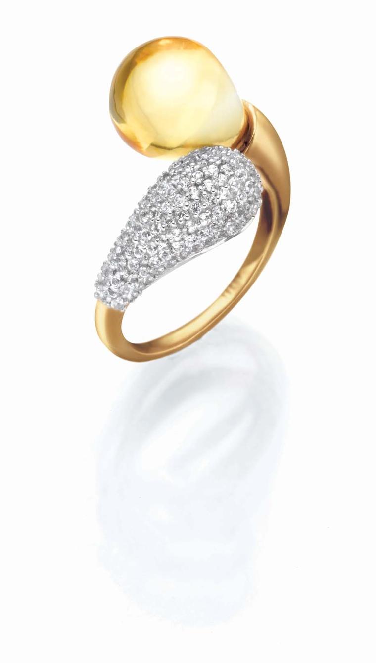 Tanishq IVA 2 collection gold ring with pavé diamonds and a citrine curling around the finger.