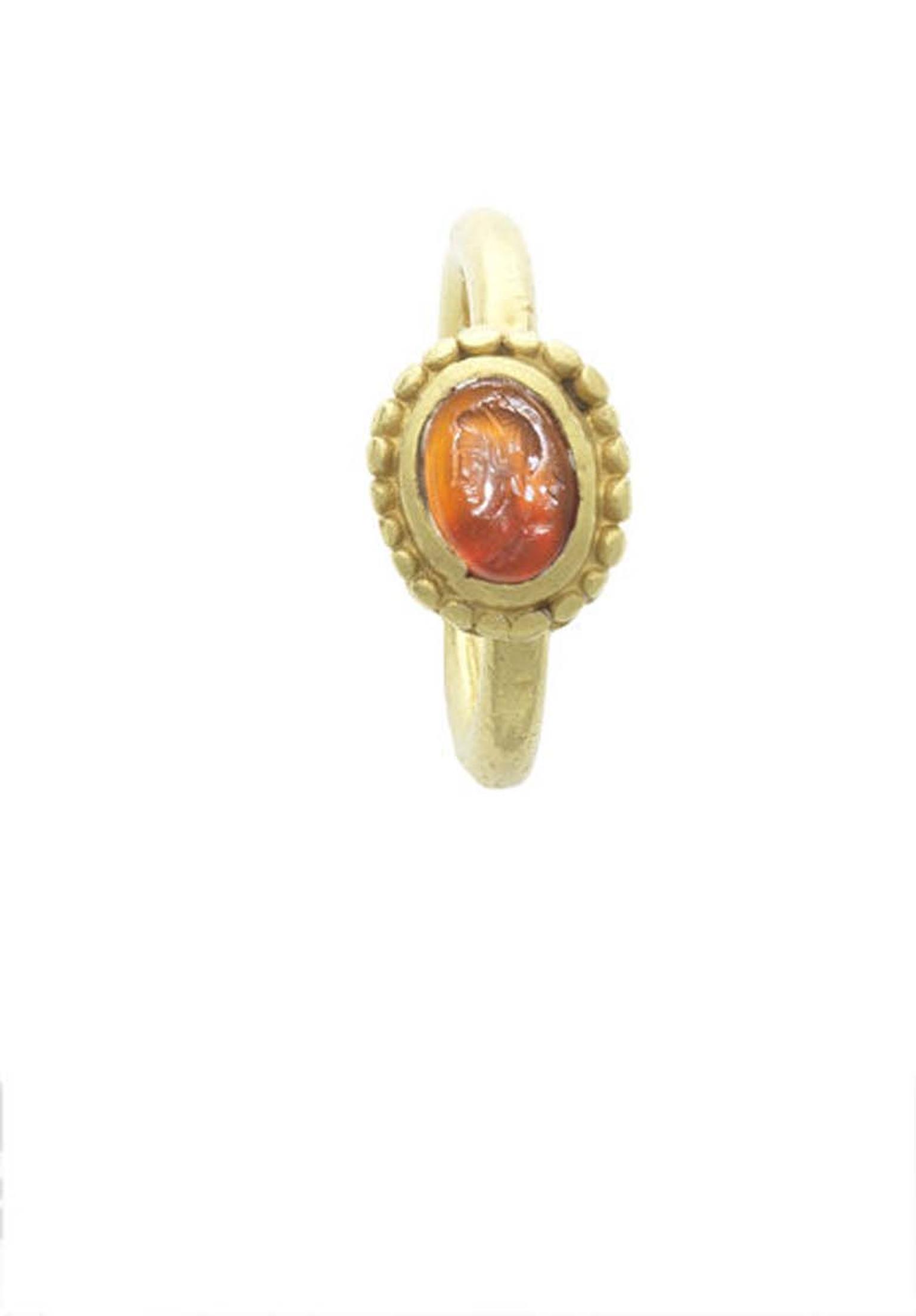 An intaglio ring of Diana, goddess of the hunt, carved with her quiver of arrows in fire orange carnelian stone, dating from circa 5th century AD.