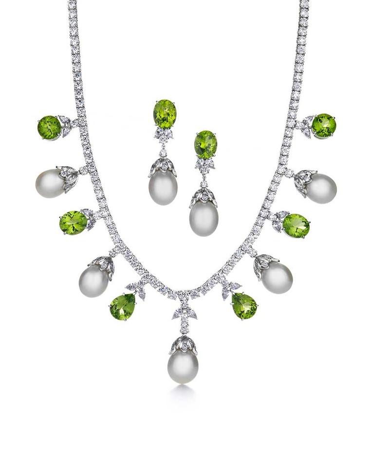 Tiffany & Co. Triple Strand platinum necklace and earrings featuring white South Sea pearls, bright green peridots and diamonds.
